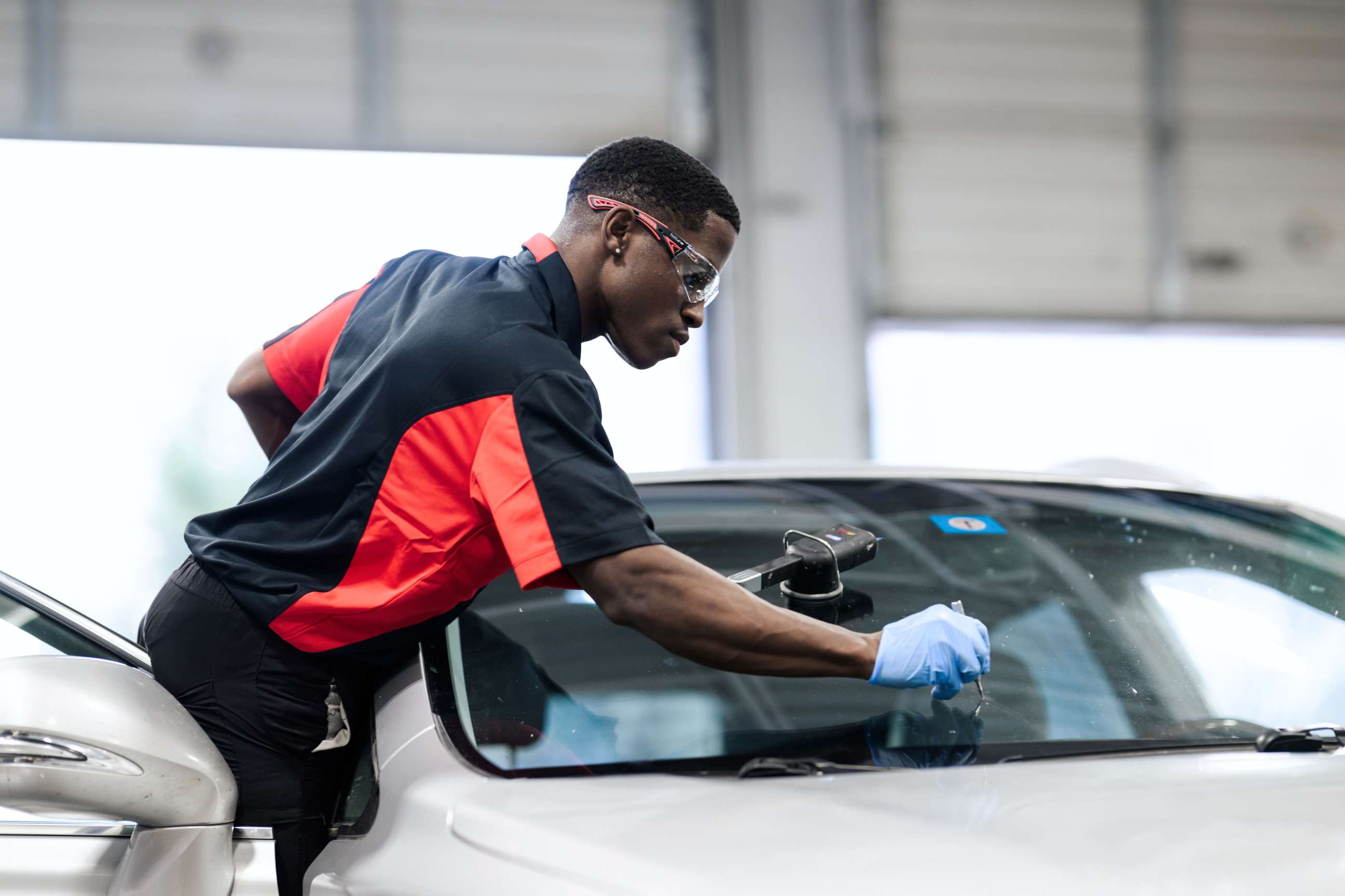 Technician repairing windscreen
